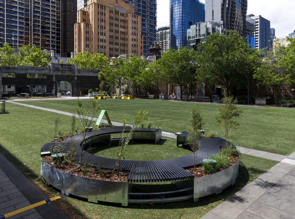 The final installation is made of stainless steel and composite timber slats. These materials were selected due to their durability in outdoor spaces. Holes are placed in the bottom of the planter boxes to allow for drainage. Further funding is sought to line the steel boxes with plant-friendly material and to inscribe artworks on the outward-facing surfaces of planter boxes. Note the four circular green speakers that are networked to a computer system located beneath the seating[1].